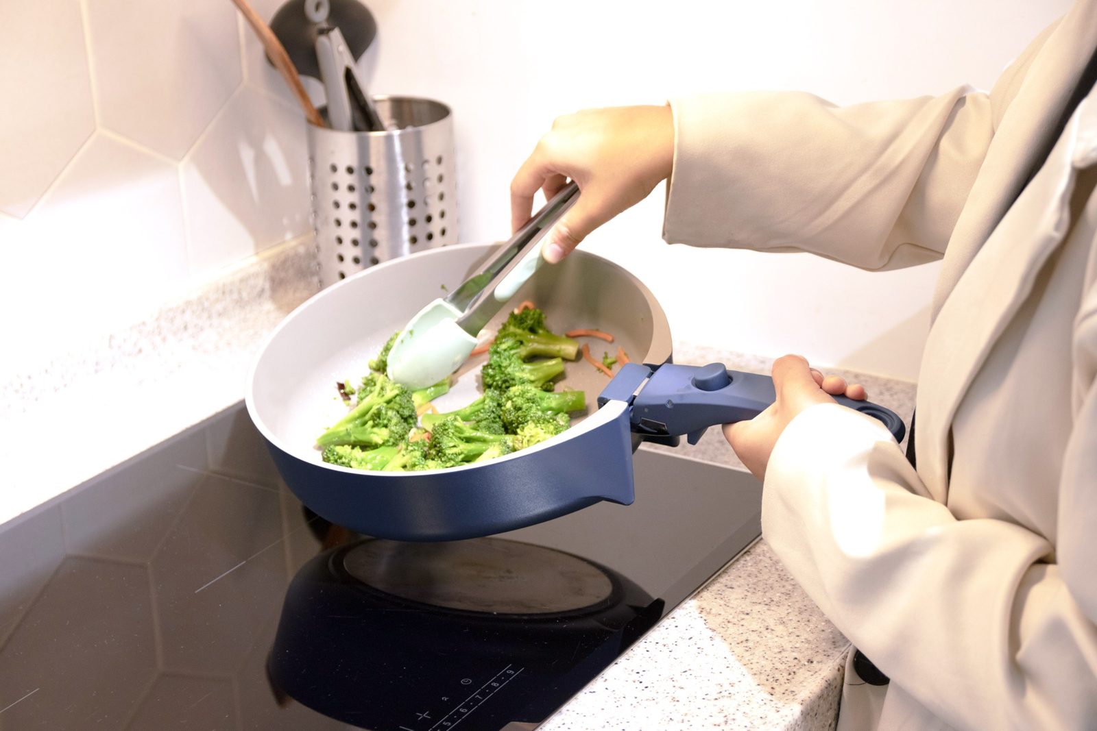 Stir-frying broccoli in the blue V-Pan on an induction cooktop