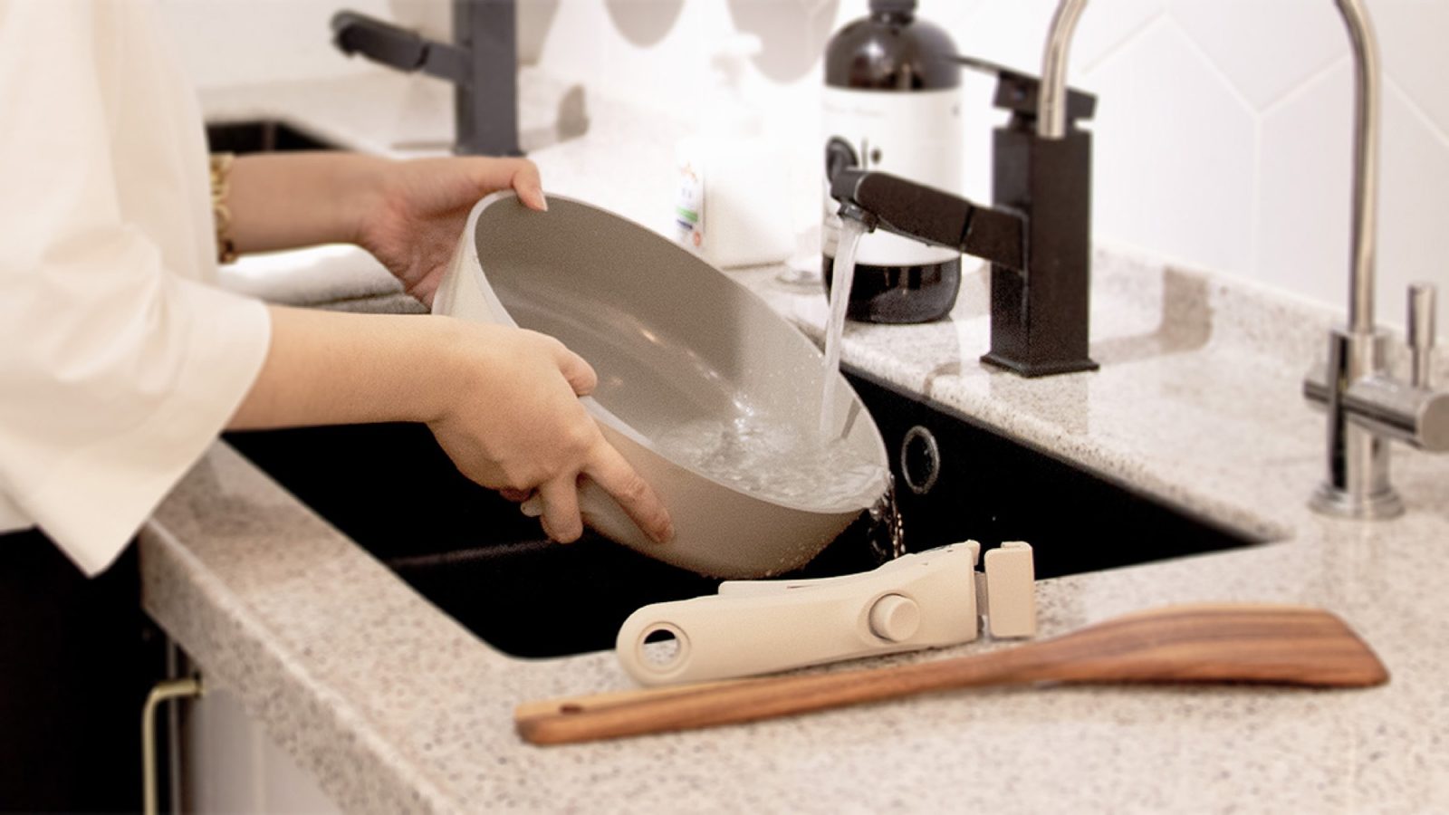 Washing the V-Pan body with the handle detached beside the sink